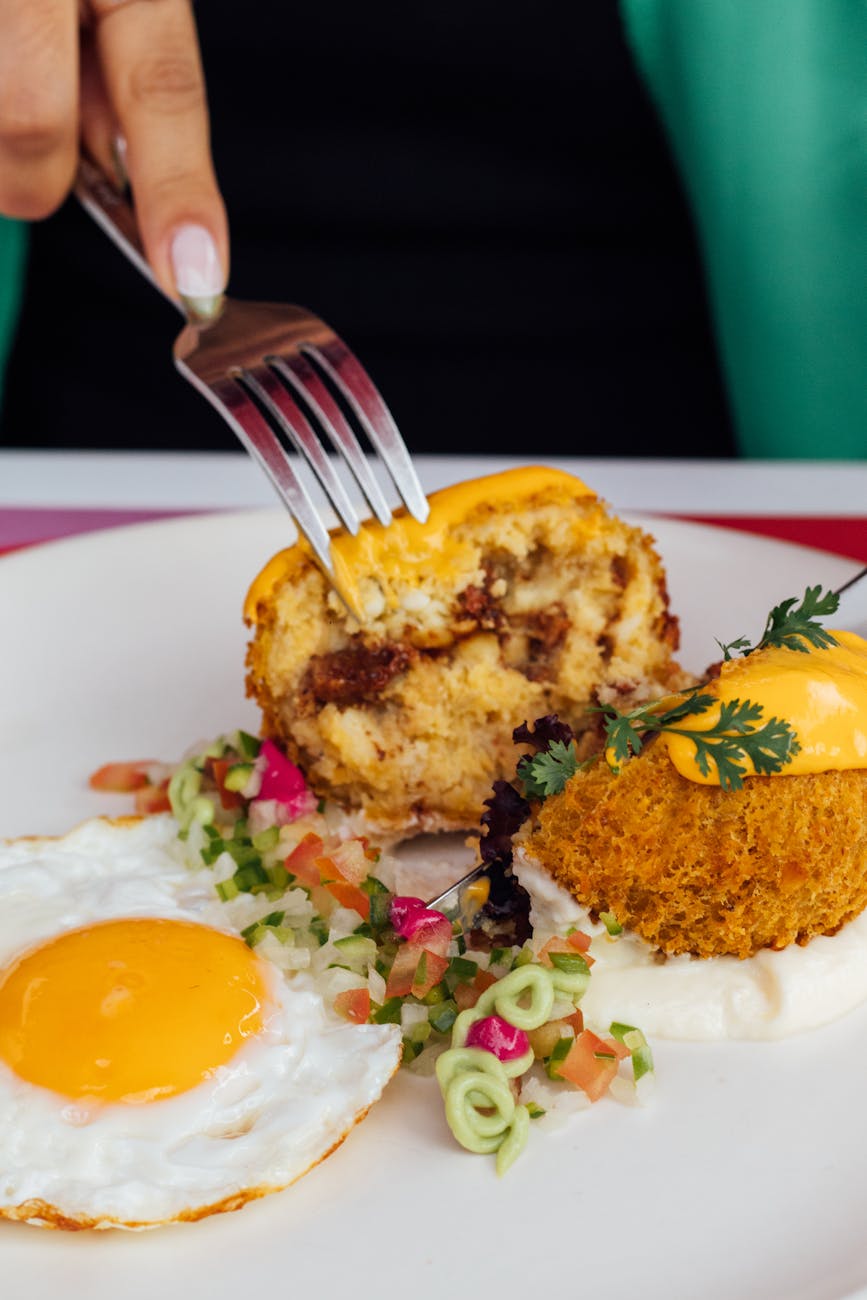 Finely diced carrots, celery, and onions (soffritto) gently sautéing in a pan with olive oil, creating an aromatic base for cooking.
