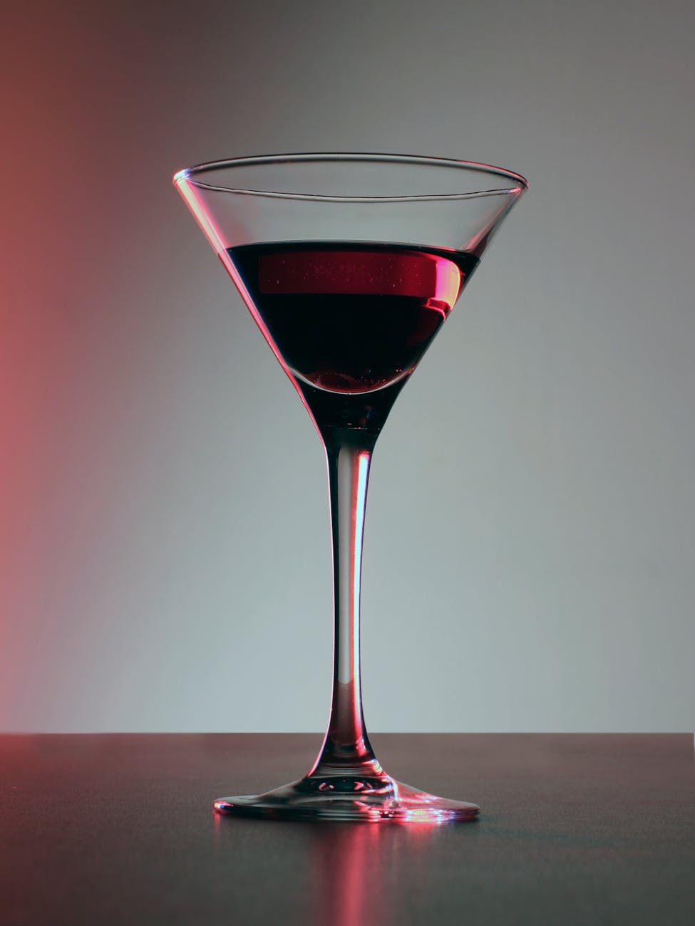 Close-up of a glass of ruby red wine on a wooden table