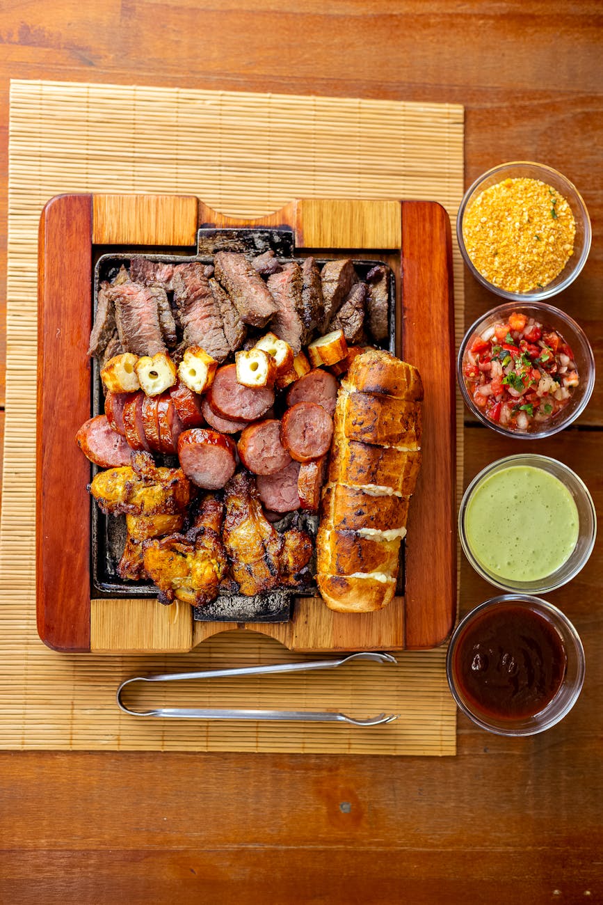 A perfectly grilled ribeye steak topped with fresh green chimichurri sauce on a white plate