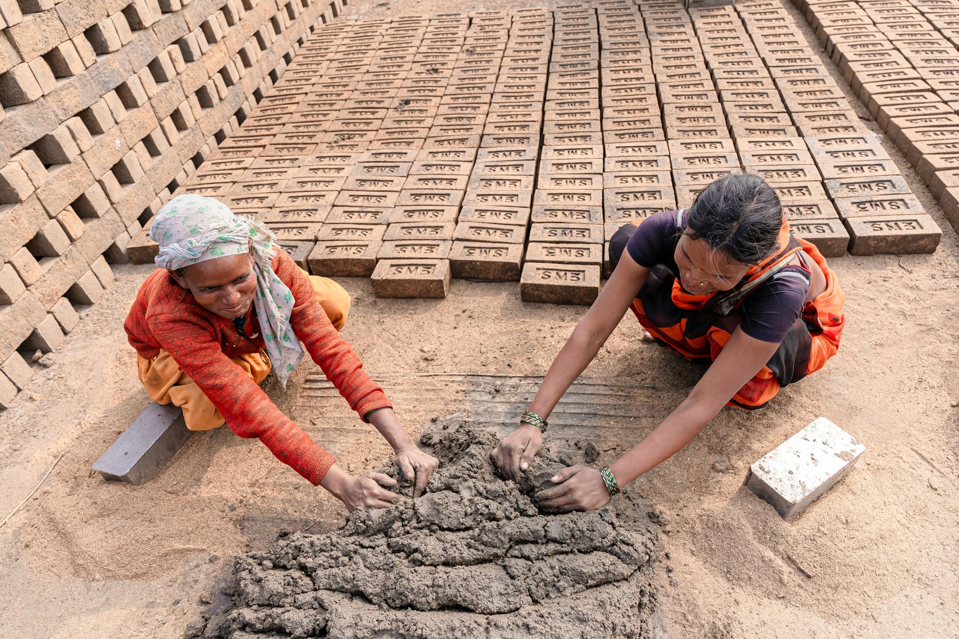People participating in a farm workshop, possibly gardening or preparing fresh produce in a rustic setting.
