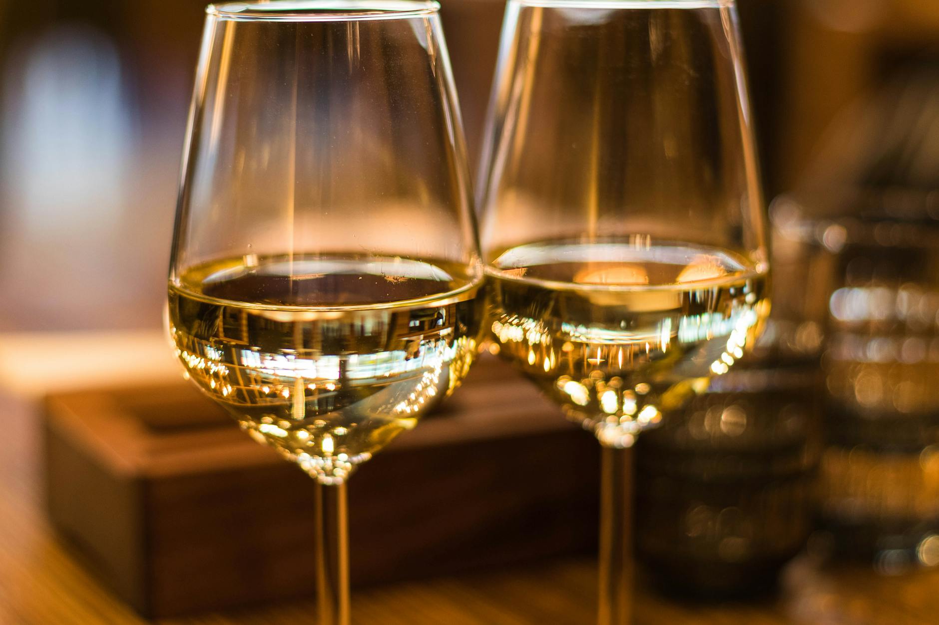 A close-up of a glass filled with golden Chardonnay wine, capturing its clarity and inviting hue.